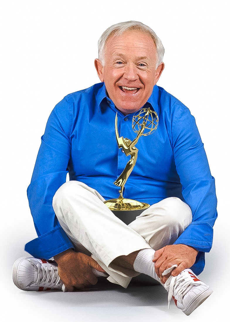 Actor Leslie Jordan seated with an Emmy award in his lap