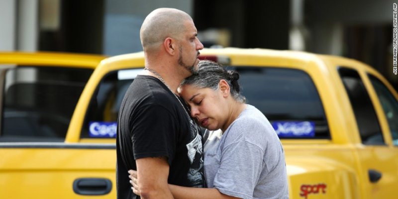 Pulse nightclub DJ Ray Rivera, is consoled by a friend outside of the Orlando Police Department.