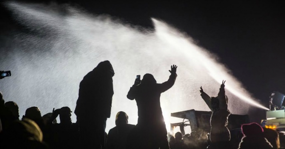 Law enforcement officers spray protesters with water cannons in below-freezing temperatures. (Photo: Tara Houska/Twitter)