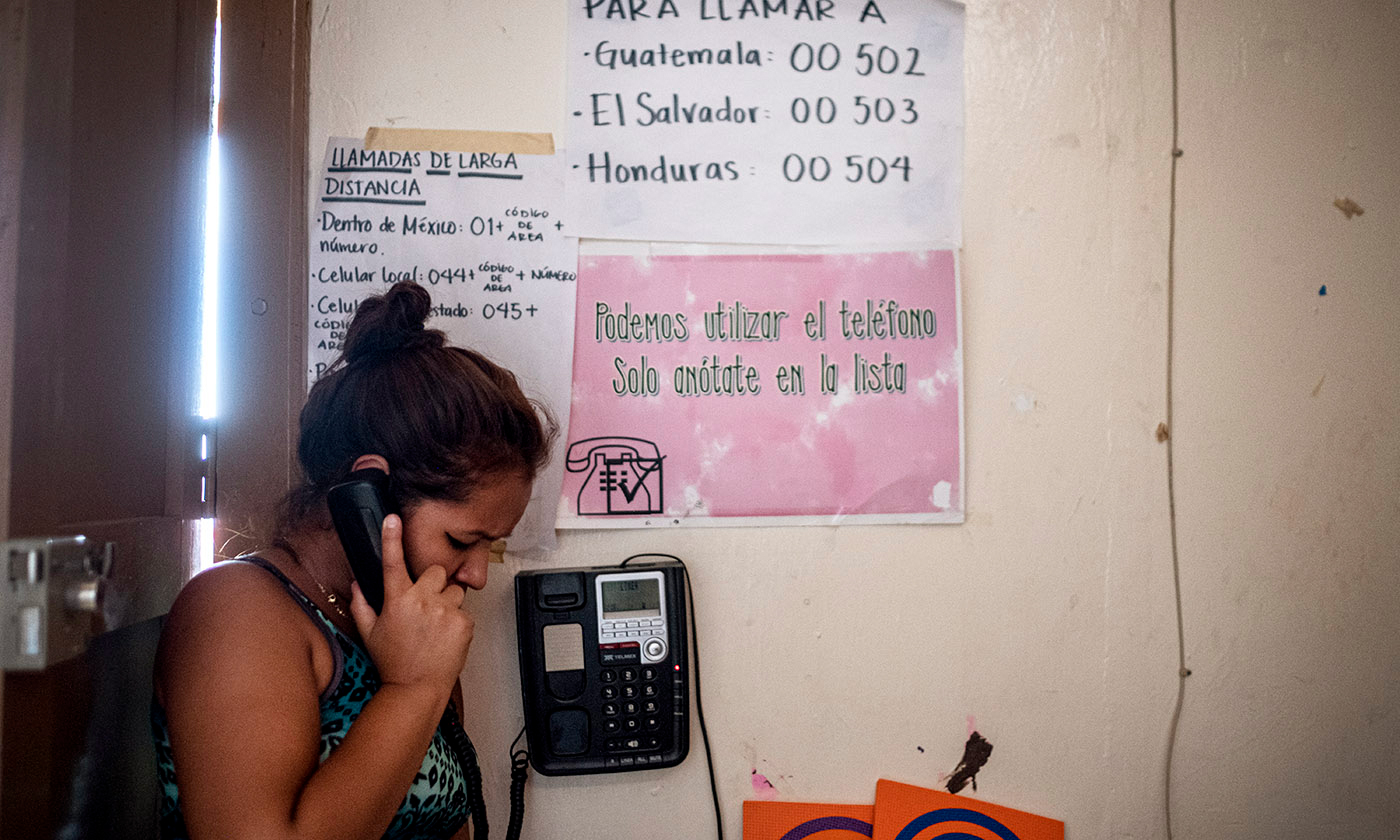 A participant in T’ja Xuj makes a free phone call home to her family.