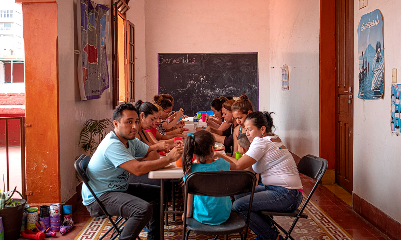 The women and their children, plus volunteers, share a meal each Sunday.